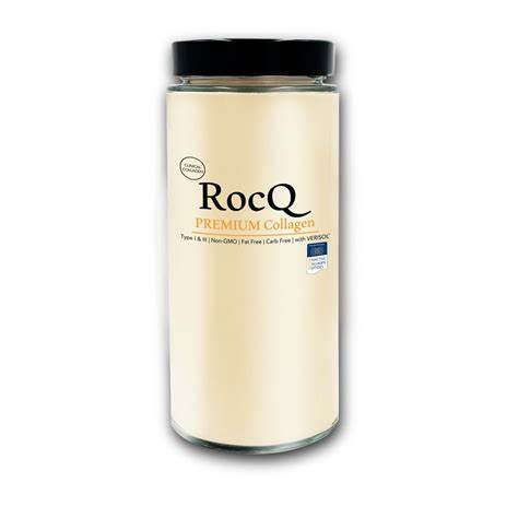 A clear jar with a black lid containing RocQ Premium Collagen powder. The label displays the brand name and product description.