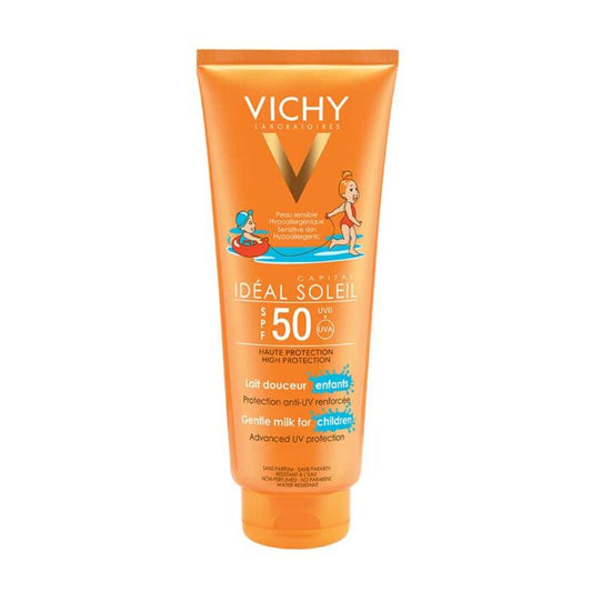 A tube of VICHY IDEAL SOLEIL Kids Milk Sunscreen with SPF 50+, featuring illustrations of children playing in water and the product branding prominently displayed.