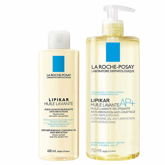 Two pump bottles of LA ROCHE-POSAY Lipikar Cleansing Oil, one smaller and one larger with yellow labels and blue branding, indicating the product is for cleansing and caring for lipid-rich skin.