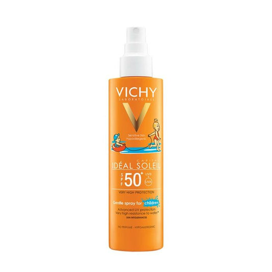 A bottle of VICHY IDEAL SOLEIL Kids Spray Sunscreen with SPF 50+. The packaging is predominantly orange with illustrations of children playing by the water and the VICHY brand logo.