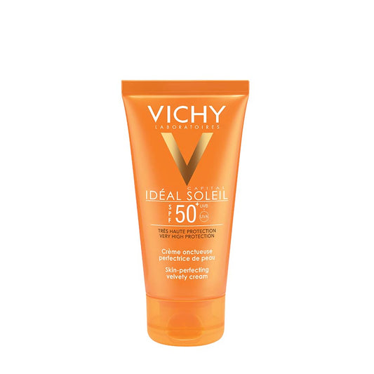 A tube of VICHY IDEAL SOLIEL VELVETY CREAM SPF50+ sunscreen with orange packaging.