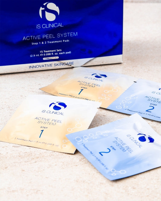 Packaging and individual sachets of iS Clinical Active Peel System, with branding visible.