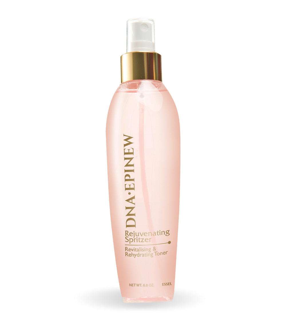 A clear spray bottle with pink liquid, labeled as 'Rejuvenating Spritzer' for skincare.