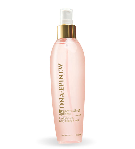 A clear spray bottle with pink liquid, labeled as 'Rejuvenating Spritzer' for skincare.