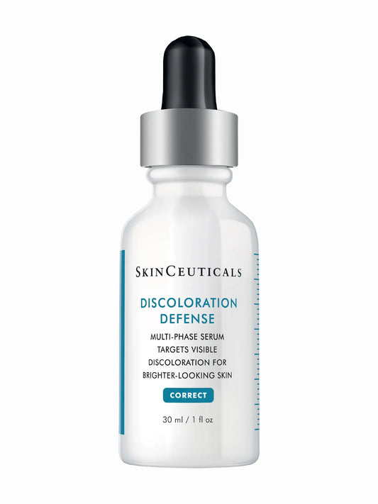 A bottle of SkinCeuticals Discoloration Defense serum with a dropper top, labeled for correcting dark spots and hyperpigmentation.
